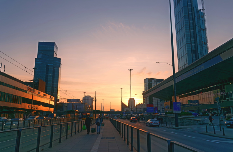 15 - A vibrant sunset over the modern skyline of Warsaw, Poland, specifically featuring the prominent Złote Tarasy complex